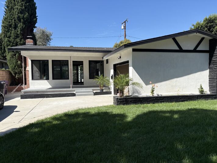 Front elevation of 2715 Petaluma showing modern black-and-white facade and front lawn