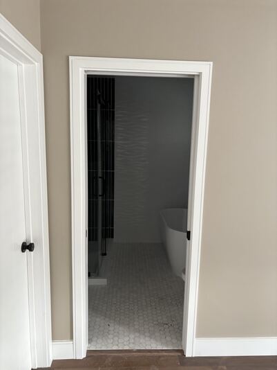 Bathroom doorway view showing freestanding tub and glass walk-in shower